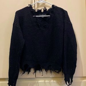 Knitted sweater with distressed sleeve cuff, bottom & neck line.